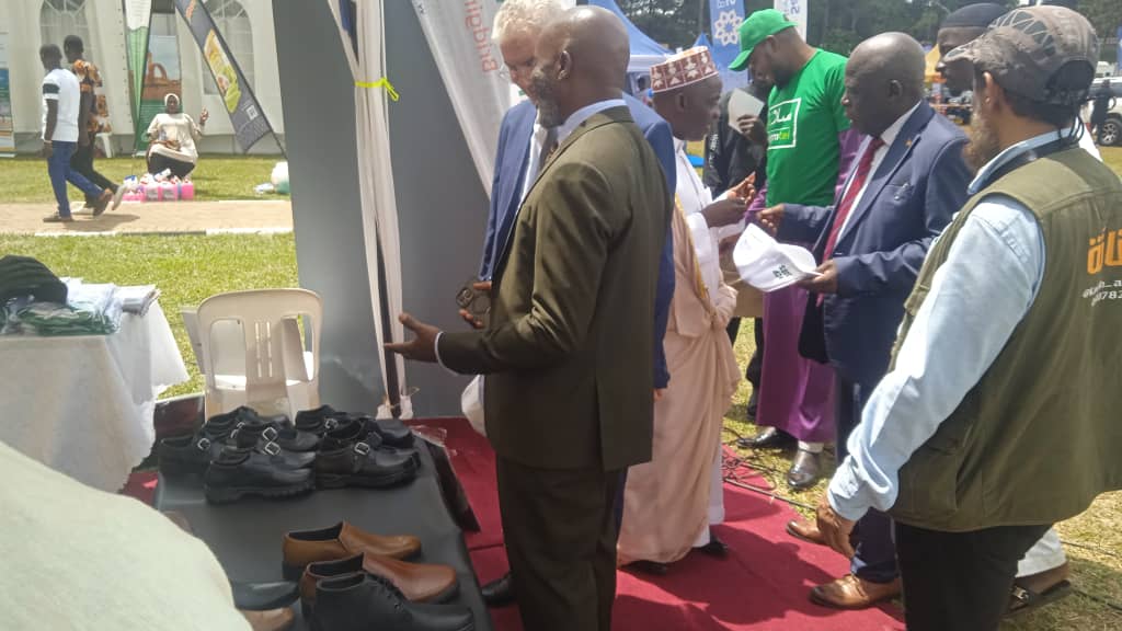 Members presenting Ugandan-made leather footwear to visiting dignitaries